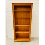 A pine book case with four shelves (H180cm W80cm D27cm)