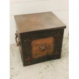 A copper coal scuttle with fleur-de-lys detailing