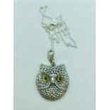 A silver lucky owl pendant necklace with glass eyes on silver chain