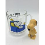 A Vintage Snoopy glass mug and wind up toy