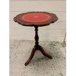 A mahogany wine table on pedestal legs with red inlay centre piece