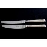 Nine silver handled table knives (25cm) and nine dessert .knives (22.3cm) Hallmarked 1975 Yates
