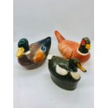 Three lidded ceramic egg holders in the form of ducks and pheasants