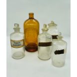 A selection of vintage pharmaceutical bottles and a bottle by C Mumby and Co ltd of Portsmouth