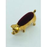A brass pincushion in the form of a pig