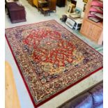A large machine tooled red and blue rug