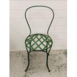 A green metal bistro chair