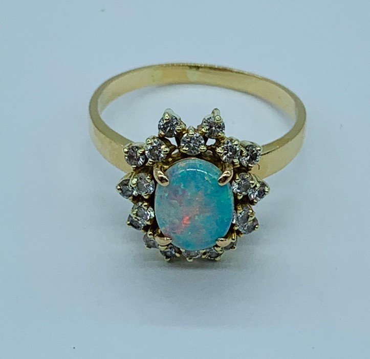 An opal and diamond cluster ring set with twenty diamonds. - Image 5 of 6