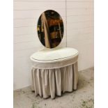 A ladies oval dressing table with oval mirror and linen skirt
