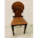 A carved wooden hall chair