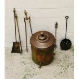 A round lidded brass coal scuttle on three clawed feet with various fire irons