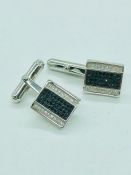 A pair of silver and CZ cufflinks