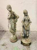 Two garden statues, one of a goddess and one of a farm girl