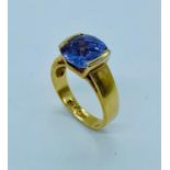 An 18ct plated gold ring with large central stone.