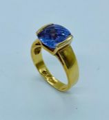 An 18ct plated gold ring with large central stone.