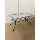 A glass topped metal frame dining table