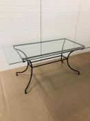 A glass topped metal frame dining table