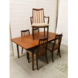 An extendable mid century dining table by McIntosh with five G plan dining chairs to include one