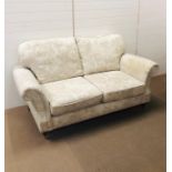 A Marks and Spencer "Salisbury AW14" two seater sofa in dioma floral natural fabric with wooden feet