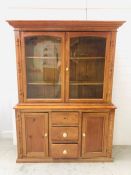 A large pine dresser with glass doors, shelves, cupboards and three drawers (H198cm D42cm W144cm)