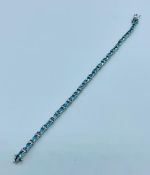 A Tennis bracelet in silver set with aquamarines