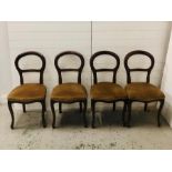 Four balloon back chairs on cabriole legs with upholstered seats