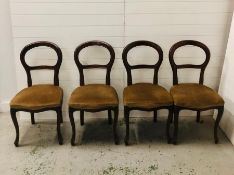 Four balloon back chairs on cabriole legs with upholstered seats