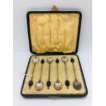 A cased set of silver berry spoons