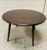 An Ercol low circular elm coffee table