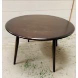 An Ercol low circular elm coffee table