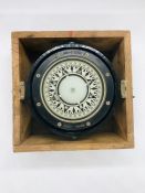 A ships compass in a wooden box