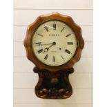 A carved wooden wall clock by J. More, Sussex (with key)