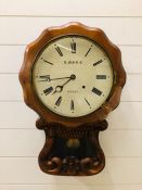 A carved wooden wall clock by J. More, Sussex (with key)