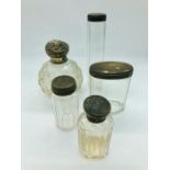 Five various silver topped dressing table glass jars