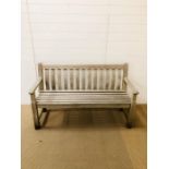 A solid wooden bench 150cm L x 92cm H x 59cm D