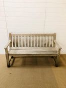 A solid wooden bench 150cm L x 92cm H x 59cm D