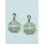 A pair of silver and CZ set earrings with opal panel