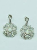 A pair of silver and CZ set earrings with opal panel