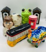 A collection of eight moneyboxes various styles and shapes