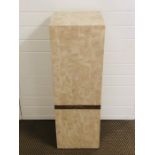 A marble/ travertine effect pedestal