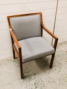 An upholstered mid century open arm chair by Mines and West