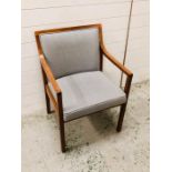 An upholstered mid century open arm chair by Mines and West