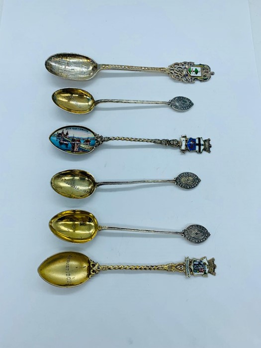 A small selection of collectable silver spoons, some with enamel