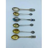 A small selection of collectable silver spoons, some with enamel