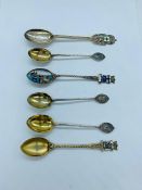 A small selection of collectable silver spoons, some with enamel