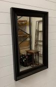 A black framed mirror