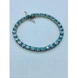 A Tennis bracelet in silver set with aquamarines