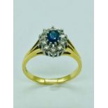 An 18ct yellow gold sapphire and diamond cluster ring