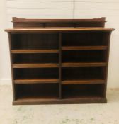 A large free standing bookcase with eight shelf compartments and upper mantle shelf (W165cm D40cm