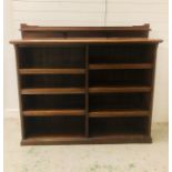 A large free standing bookcase with eight shelf compartments and upper mantle shelf (W165cm D40cm